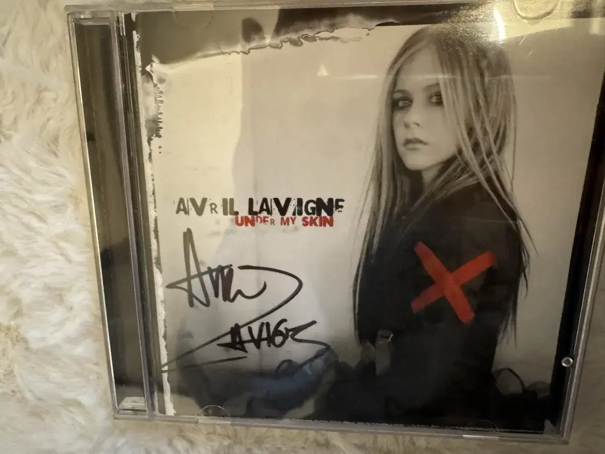 sign bulk, including CDs and DVDs, signed by Avril Lavigne, are for sale.