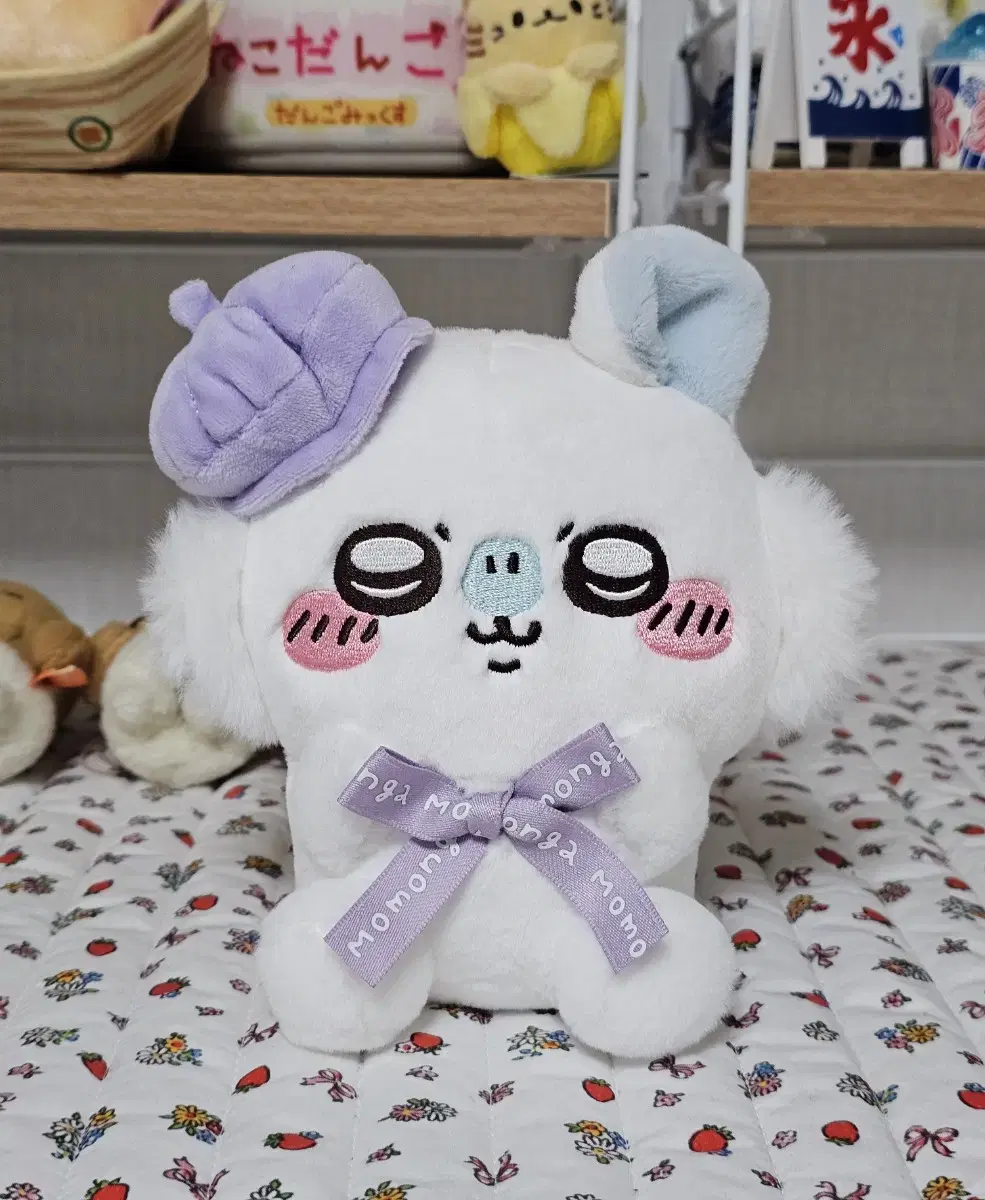 Chiikawa and Tokyo's sister sitting on a momonga doll