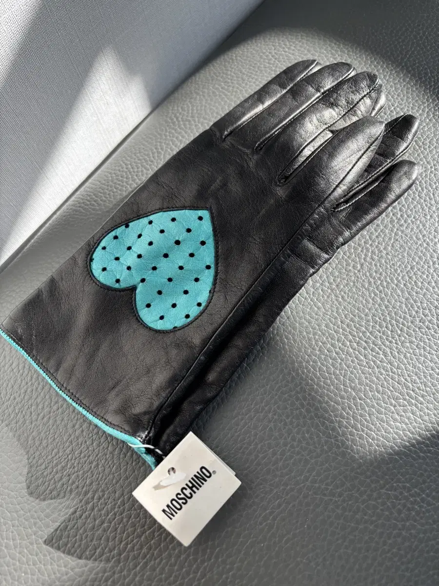 Moschino gloves with a tag on them, brand new