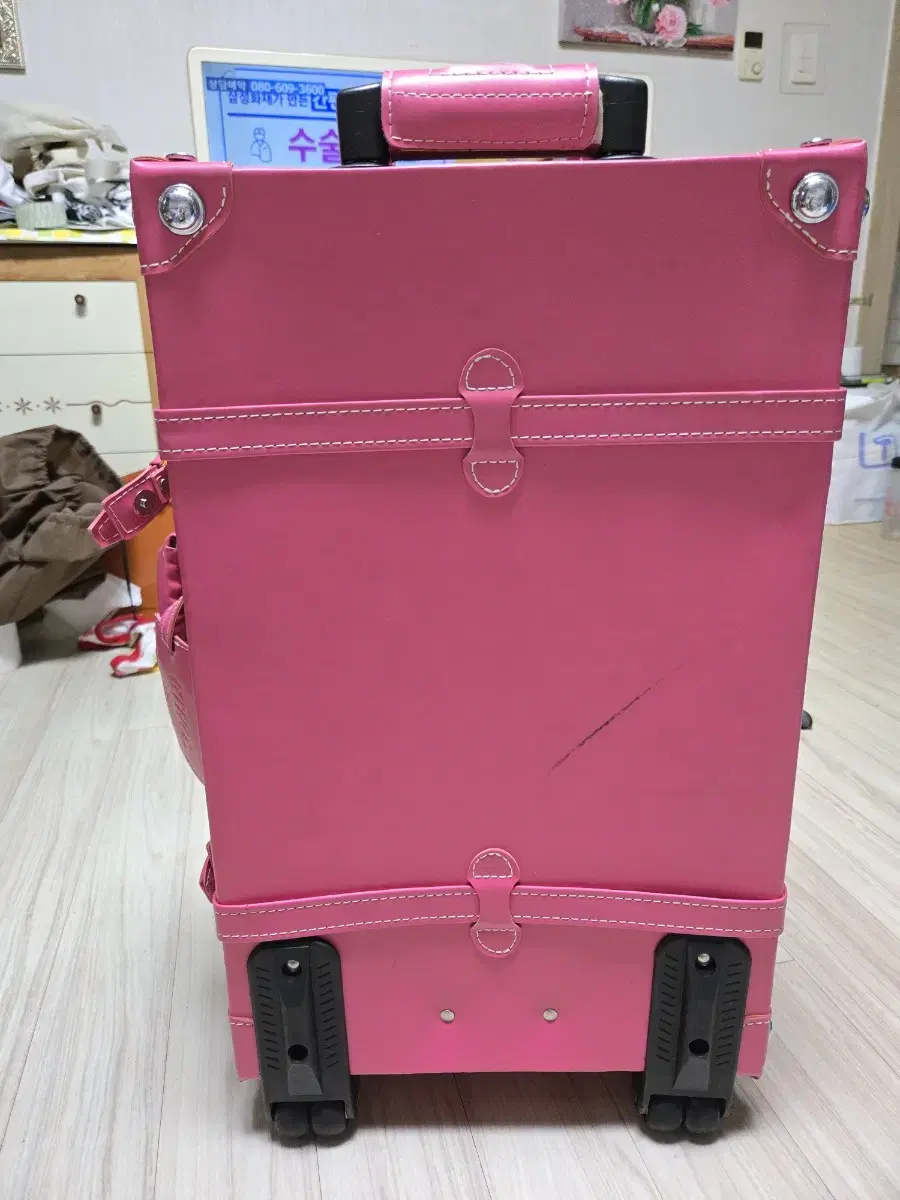 We are selling a 22-inch pink ETHOS carry-on suitcase.