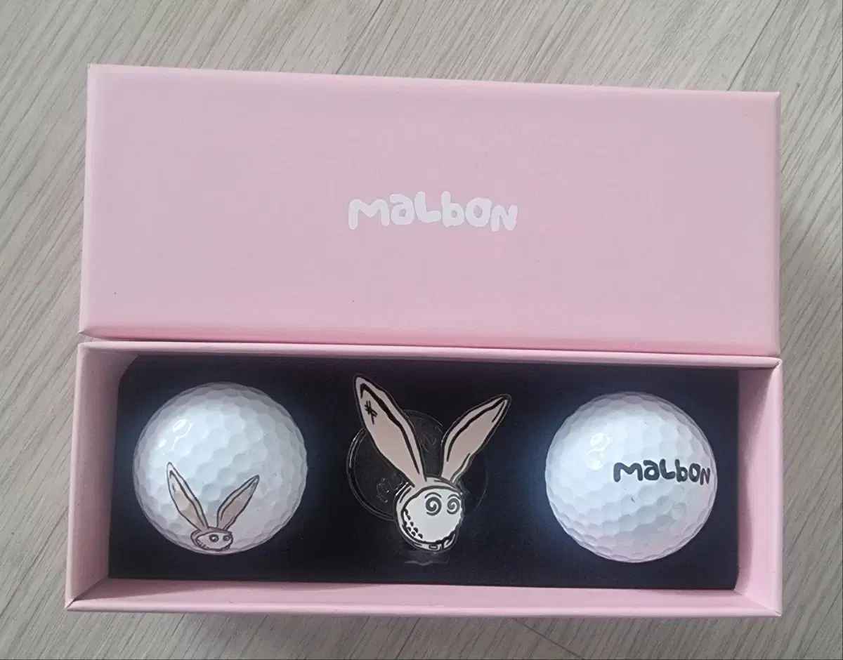 I'm selling a set of rabbit ball markers and two golf balls. Golf