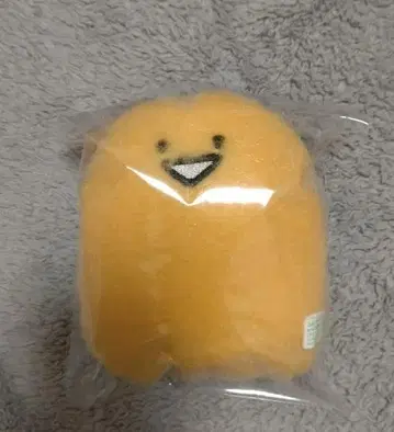 오렌지 컬러의 웃는 봉제 인형