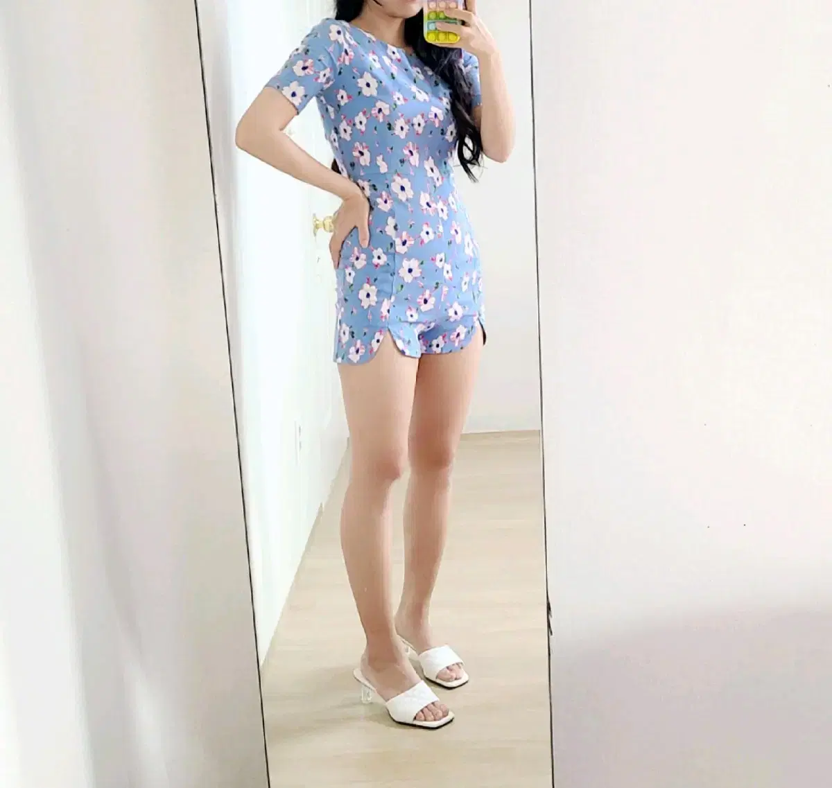 A short jumpsuit with a lovely floral pattern in a cool sky color.