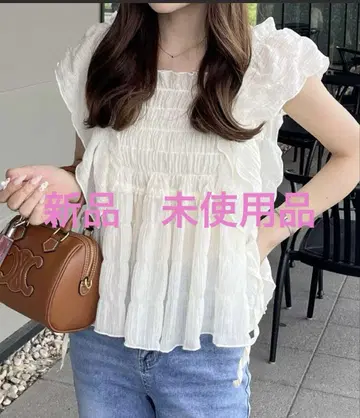 nelliy. 프릴 셔링 시어 블라우스 아이보리