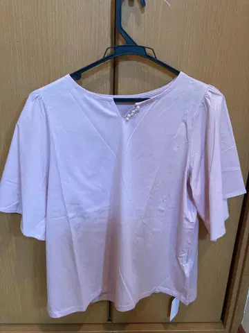 펄 버튼이 달린 핑크 반팔 상의