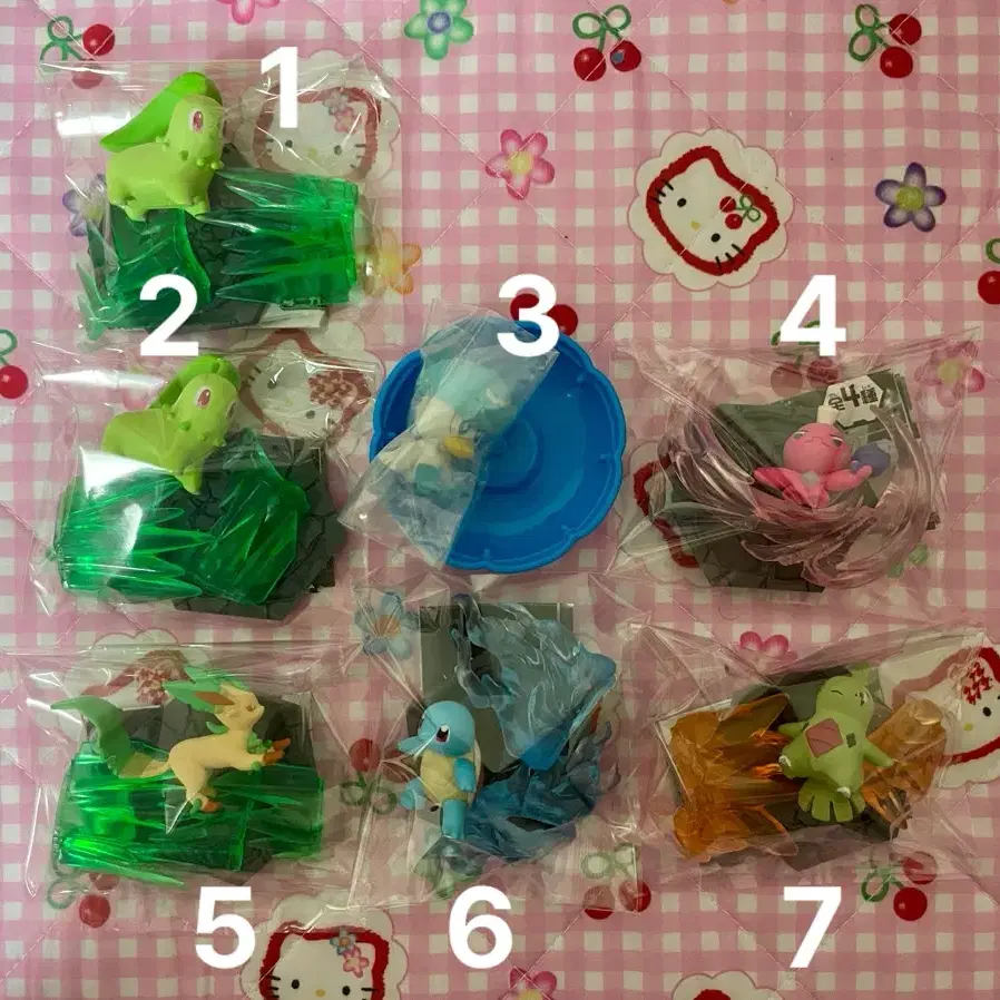 Pokémon figures (Lycanroc, Eevee, Squirtle, Larvitar, Chikorita, Leafeon, Magmar)