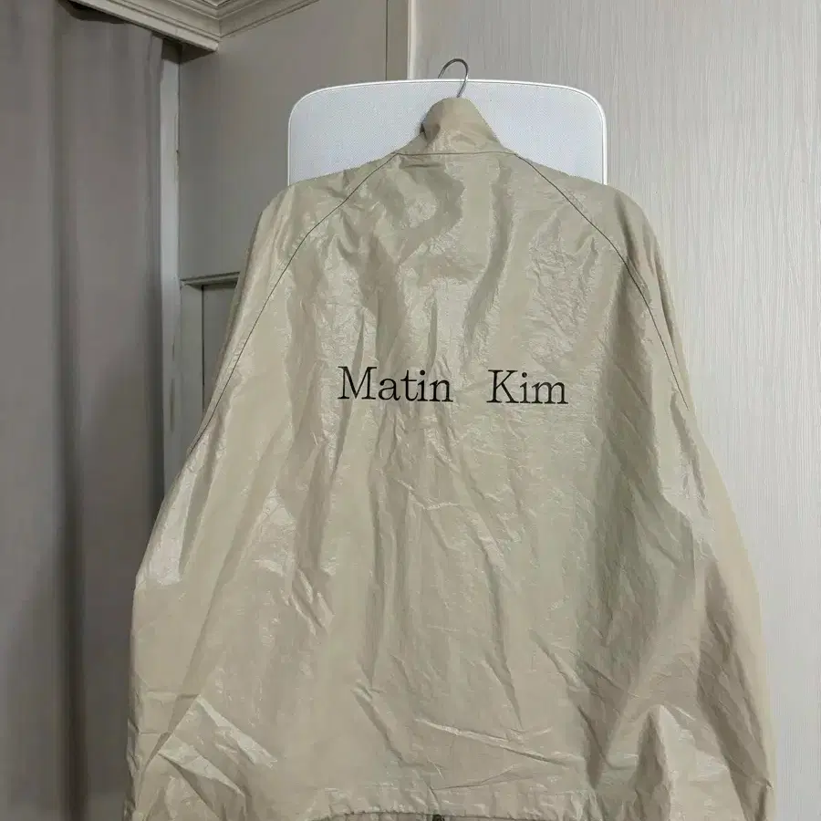 MATIN KIM | 마뗑킴 Matin Kim Logo Coating Jumper_Beige F on