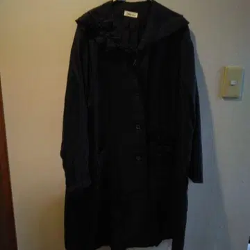 후드 부착 블랙 롱 코트, 곳곳에 꽃 모티브가 있습니다.