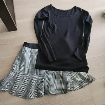 리엔다. 블랙 긴팔 니트와 체크 무늬 치마바지