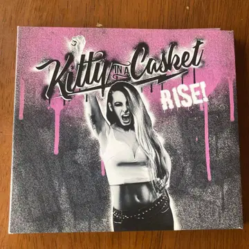 RISE kitty in a casket
