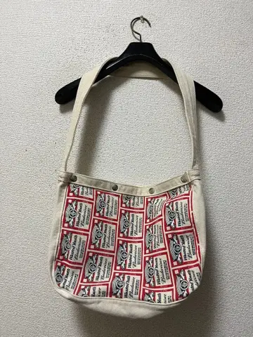 웨스티드 유스 x 버드와이저 올 패턴 캔버스 뉴스 페이퍼 백 / 아이보리