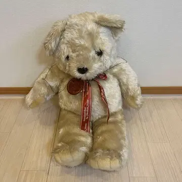 베이지색 리본 포함 봉제 인형