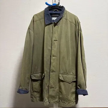 코듀로이 옷깃의 올리브색 코트