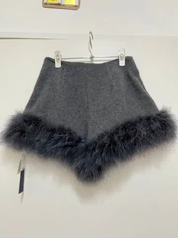 릴리 브라운 울 소재 페더 퍼 부착 숏팬츠 그레이 색상