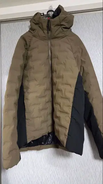 후드 부착 카키와 블랙의 자켓