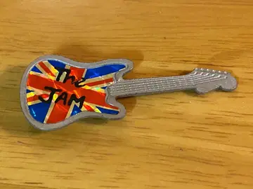 The Jam 기타 모양 배지