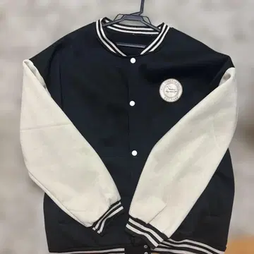 바시티 자켓 블랙과 크림색 로고 패치 포함
