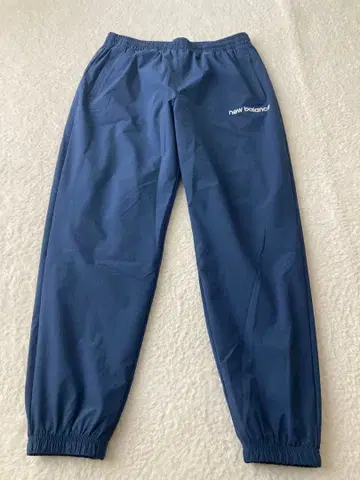 뉴발란스 2025 모델 우븐 트랙 팬츠 (AMP53170)