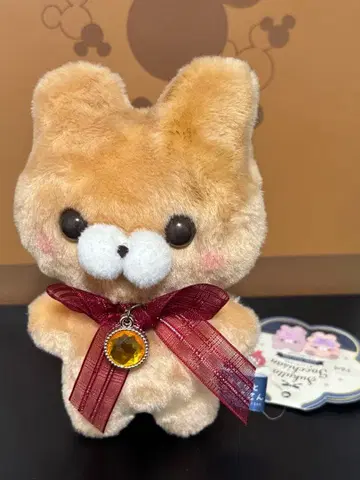 베이지색 리본 포함 봉제 인형