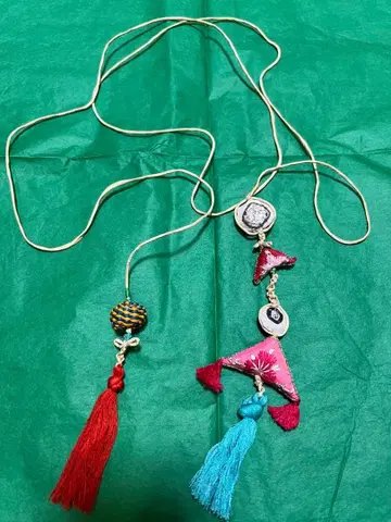 dosa lariat with large amulet