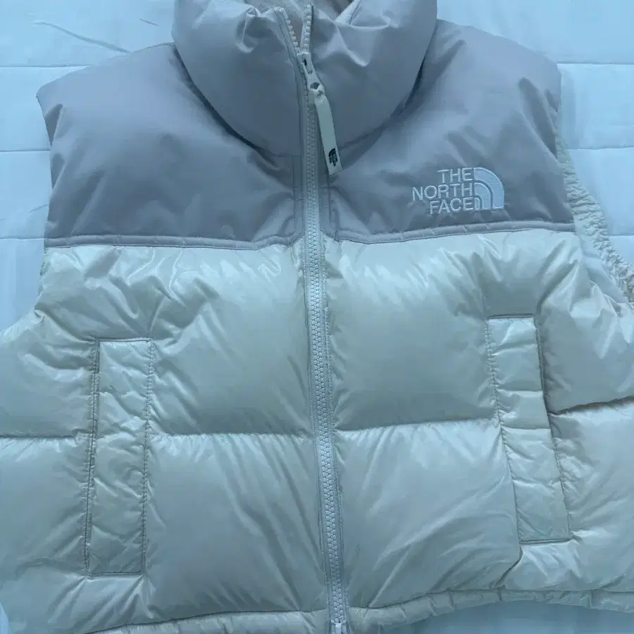노스페이스 화이트 라벨 노벨티 눕시 다운 베스트 크림